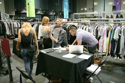 Trade show attendees browsed organic garments from eco-friendly manufacturers.
