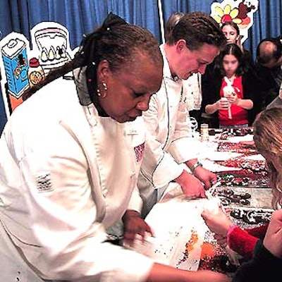 In the children's area, Corrin Patterson, graduate of the Institute of Culinary Education, and Petrossian pastry chef Christopher Broberg supervised kids as they decorated gingerbread men.
