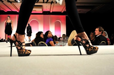 In the hotel's International ballroom, tables surrounded a T-shaped runway.