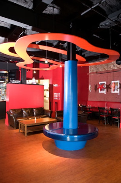The venue has high ceilings, sci-fi wall murals, and 3-D stars hanging over red leather booths.