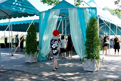 Gauzy blue drapes and topiary marked the entrance.