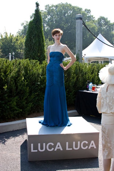 Models showed off dresses from Luca Luca on pedestals in the garden.