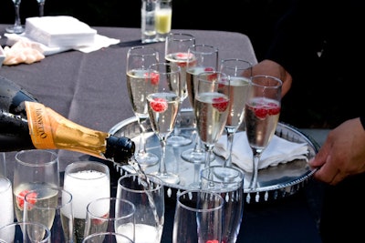 During the cocktail reception, servers offered flutes of prosecco garnished with raspberries.