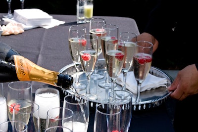 During the cocktail reception, servers offered flutes of prosecco garnished with raspberries.