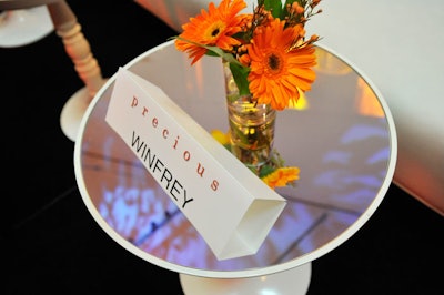 Small glass vases holding orange gerbera daisies sat atop reserved tables for V.I.P. guests like executive producer Oprah Winfrey, who was expected to attend the reception but hadn't arrived by the time the media cleared the red carpet.
