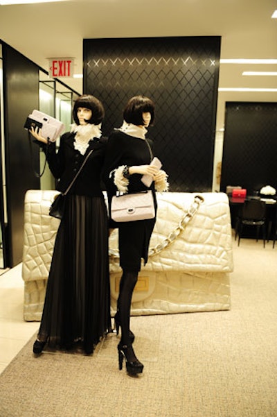 A giant handbag decorated the entrance to the custom bag salon. Is it just me, or do the mannequin wigs resemble Anna's silhouette?
