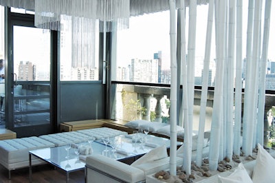 White-lacquered bamboo divides the room and white fringe embellishes the venue's chandeliers.