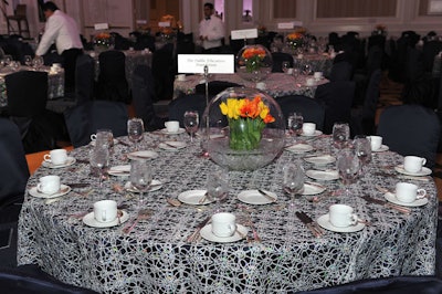 Navy blue tablecloths were topped with silver sequined lace overlays.
