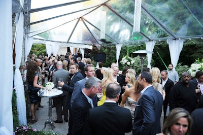 Approximately 200 guests, including Bill Clinton and Elvis Costello, mingled in a clear-topped tent at the home of Edward Rogers prior to a fund-raising dinner for OneXOne Sunday.