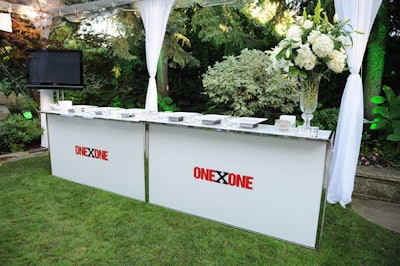 The OneXOne logo adorned white bars on the lawn of the Rogers' home.