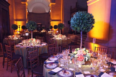 JLB Floral topped the dinner tables with topiary trees with green and pink roses and hydrangeas at the base of each arrangement.