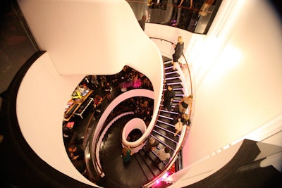 The store's central spiral staircase became a runway in its own right as guests teetered over the railing on each floor to catch a glimpse of new arrivals.