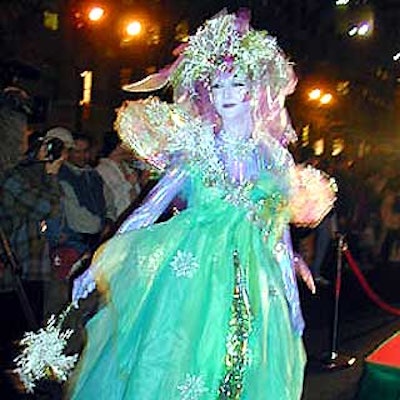 A holiday fairy clad in an iridescent cellophane dress mingled with the crowd. (Photo by Martha Cooper)