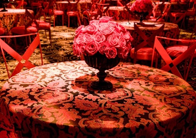 Red roses—Poiret's logo on his dress labels—filled 140 low black glass vases on tables throughout the space.