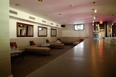 Also located on the first floor is a more relaxed lounge with striped banquettes and a bar lining the walls.