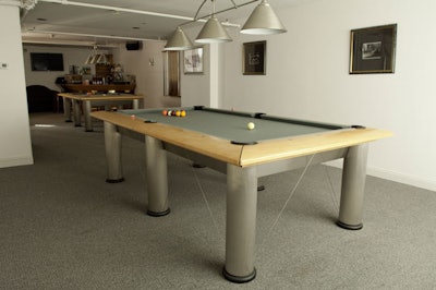 A second-floor private room features two pool tables and overhead pendant lamps.