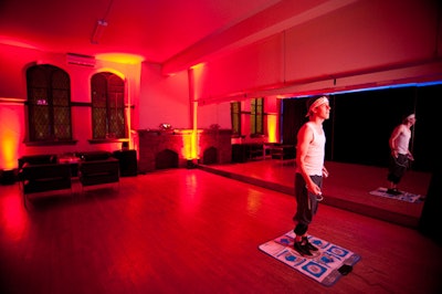 A red-lit room in the theatre included the Wii game Dance Dance Revolution.