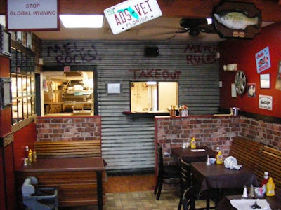 License plates, hub caps, and graffiti decorate the walls and ceiling of the Filling Station.