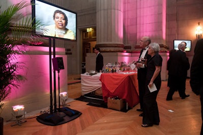 During the cocktail reception, four flat-screen TVs played a 12-minute video loop celebrating Rehm's career, including remarks from her fellow NPR journalists and pictures of Rehm with notables such as Bill Clinton, Jane Goodall, and Ted Turner.