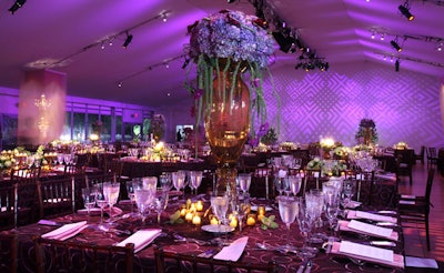 The tabletop floral arrangements included rich purple and lilac hues, towering vases, glass candelabra, and intertwining vines.