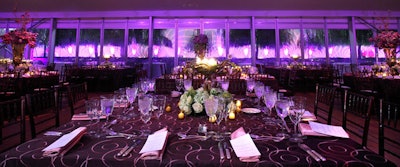 The tent's windows looked through the rain onto a purple light display projected on the Kennedy Center.