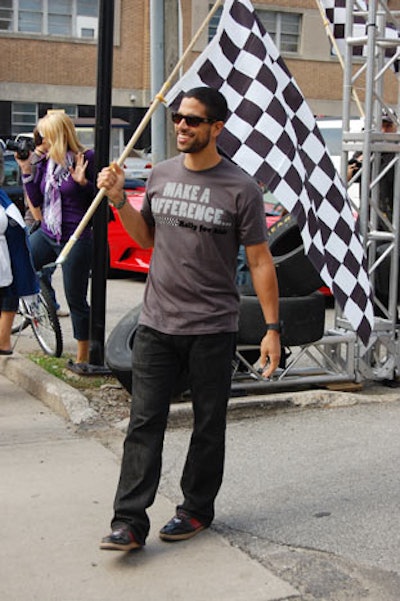 Actor and event chair Adam Rodriguez waved a checkered flag to start the car rally.