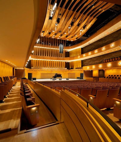 A layered wood veil above the orchestra forms a floating ceiling canopy in Koerner Hall.