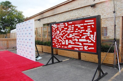 A red board covered with magnetic words sat beside the step-and-repeat at the entrance to Oasi.