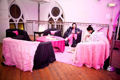 Plush pink fabric draped furnishings in the V.I.P. lounge.