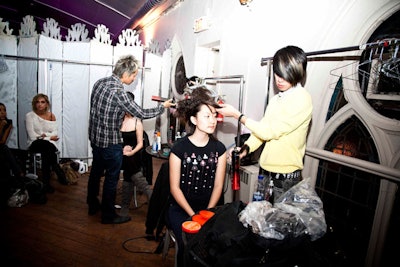 Models prepared for the runway show backstage.