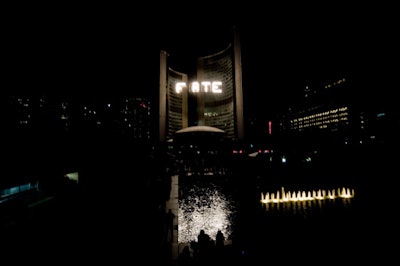 Four 7- by 7-metre alphanumeric quartz lamp arrays—suspended 65 metres in the air between the City Hall towers—displayed codes, DNA sequences, and words as part of D. A. Therrien's 'Beautiful Light: Four Letter Word Machine.'