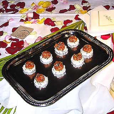 Catering company Red Wine with Fish offered salmon tartare hors d'oeuvres against a bright scatter of rose petals.