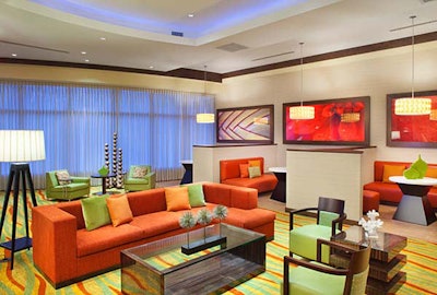 The Courtyard's lobby is decorated with traditional tropical colors of green, orange, and white with yellow accents.