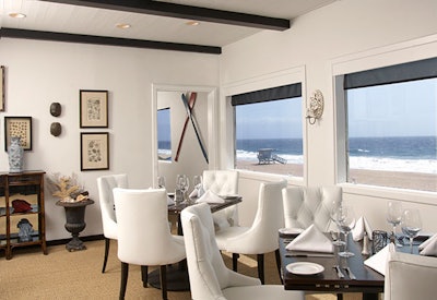 Beachy accents like oars pop against a white dining environment.
