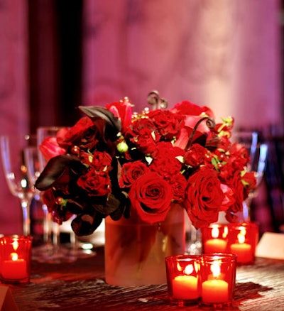 Shades of red used in the lighting also appeared in the floral arrangements, with red orchids and roses.