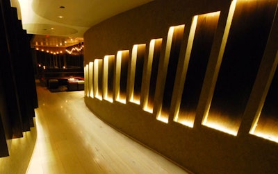 A curving, illuminated wall marks the venue's entrance.