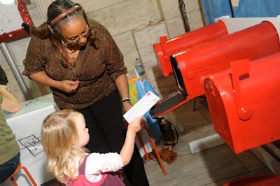 To give the postcard station a fun, interactive element, the organizers created a line of bright red mailboxes to hold completed postcards.