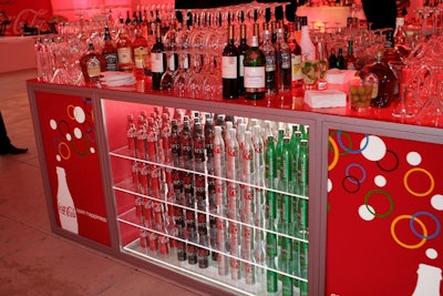 Glass-enclosed shelves of Coca-Cola products formed bases for the bars.
