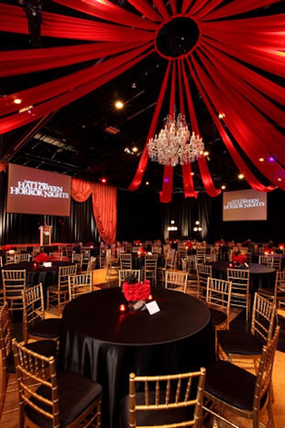 Red fabric treatments adorned the ceilings, pointing to a chandelier in the middle of the room.