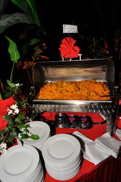 Multiple food stations served arroz con pollo, a traditional Latin dish made of rice, chicken, vegetables, and spices.