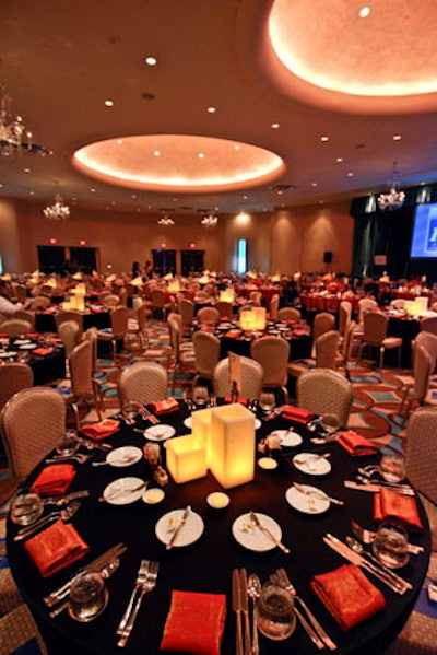 Black table clothes, orange napkins, and candle centerpieces adorned the general admission tables.