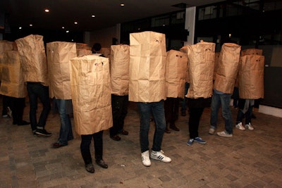 In Maria Legault's 'The Apology Project,' a group of 55 people wore large brown paper bags and congested a public walkway, apologizing to anyone who wandered through the blockade.