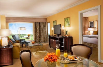 The 945-square-foot deluxe suites have a separate sitting room with a pull-out sofa and a dining area for four people.