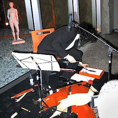 After playing for the cocktail hour, cellist-cum-performance artist Noah Hoffeld destroyed his instrument with a hammer as guests were seated for dinner.