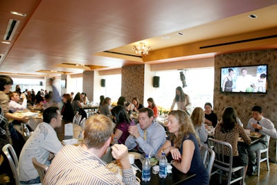 At the Bon Appétit Supper Club and Café's upstairs dining room, noisy diners paid little interest to the live Emeril Lagasse demonstration being piped in.