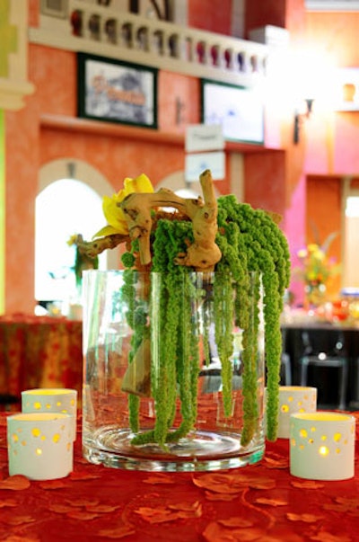 Glass vases with hanging amaranthus and fake butterflies served as one of the three centerpiece designs.
