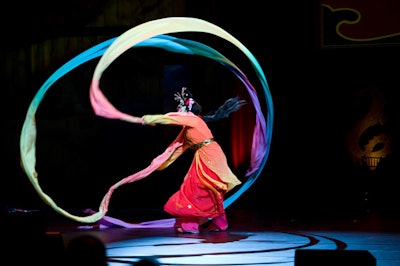 A Ka dancer created a dramatic look using ribbons that extended from costume sleeves.