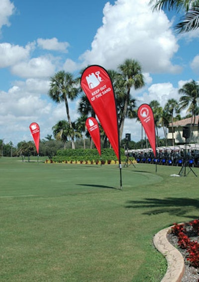 Golf-themed banners reading 'Keep Out of the Sand' and 'Aim For A Birdie' decorated the course near the first hole.