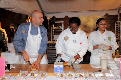 Among the chefs cooking at Friday night's Burger Bash was Michael Psilakis (far left) of Gus & Gabriel. His creation for the crowd at the Tobacco Warehouse was a blend of short rib and brisket.