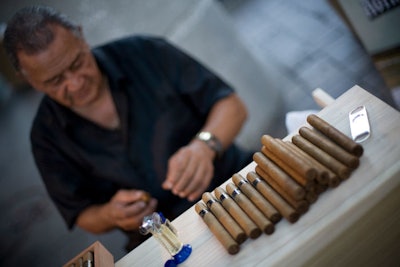 A cigar roller made fresh cigars in the lounge sponsored by TabacosSantandres Cigars.
